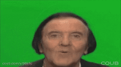 a man with a surprised look on his face is making a funny face on a green screen .