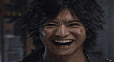 a close up of a man making a funny face with his mouth open and his eyes closed .