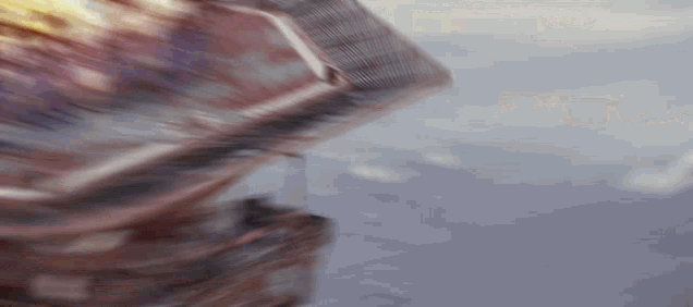 a close up of a person riding a roller coaster with a blurry background .