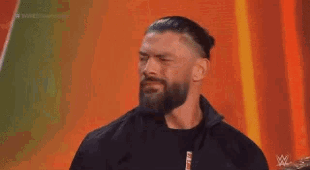 roman reigns is a wrestler with a beard and mustache .