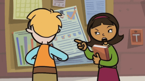 a boy and a girl are standing in front of a bulletin board with a letter t on it