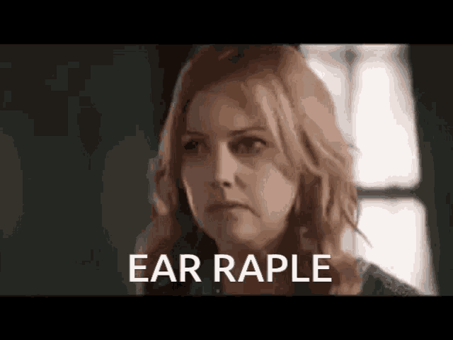 a close up of a woman 's face with the words `` ear raple '' written on it .