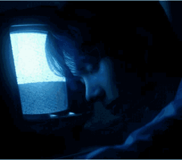 a person looking at a blue screen with static