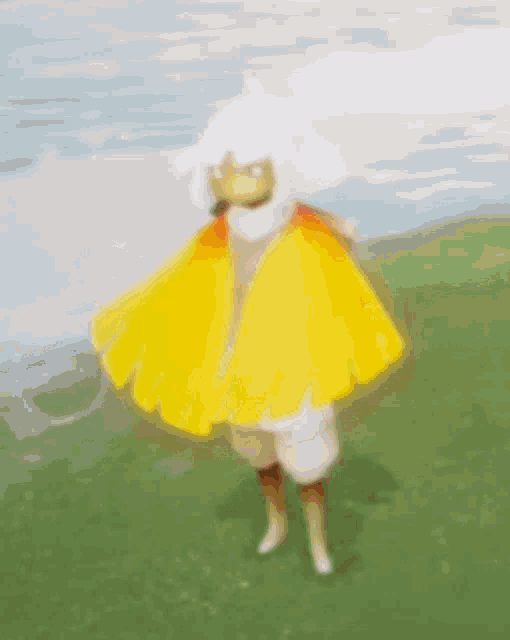 a person wearing a yellow and orange feathered cape