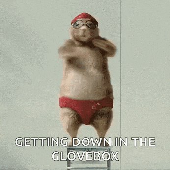 a hamster wearing a swim cap and goggles is jumping off a ladder .