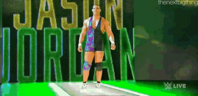 a wrestler named jason jordan is walking down a green ramp