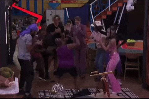 a group of people are dancing in a room .