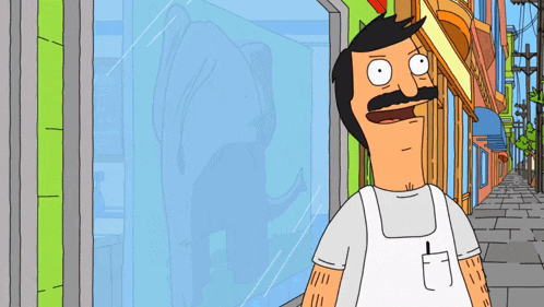 a man with a mustache is wearing an apron