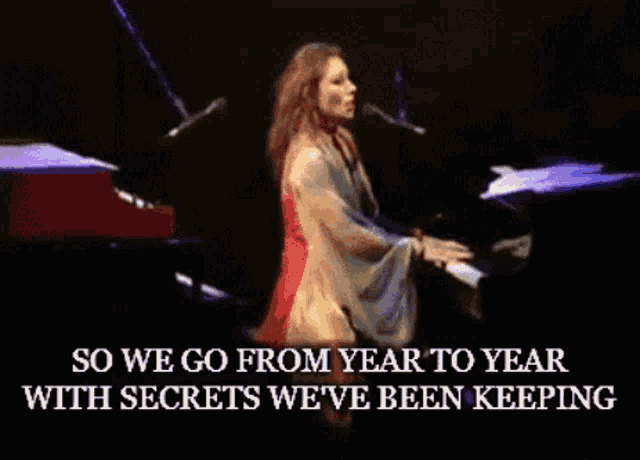 a woman singing into a microphone while playing a piano ..