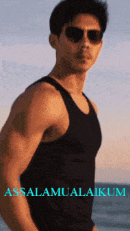 a man wearing sunglasses and a black tank top with the words assalamualaikum on the bottom right