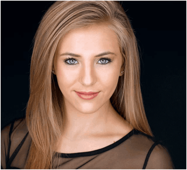 a woman with long blonde hair is wearing a black top