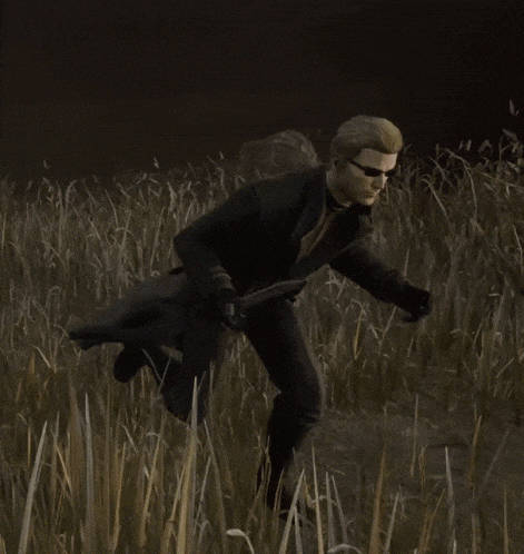 a man is running through a field of tall grass .