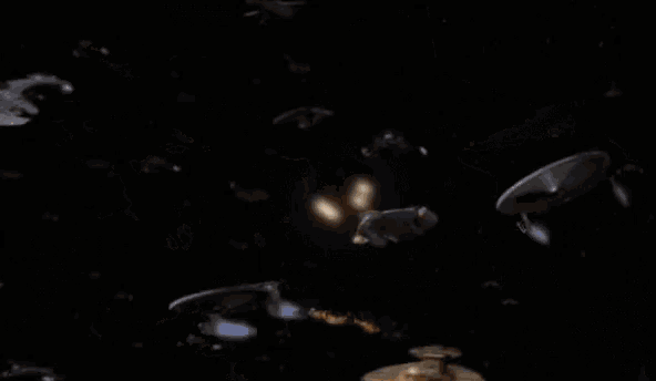 a bunch of space ships are flying in a dark space