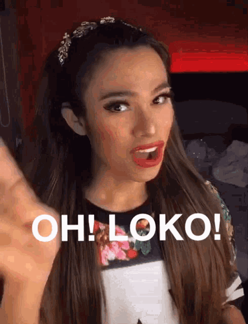 a woman with long hair is making a face and says oh loko