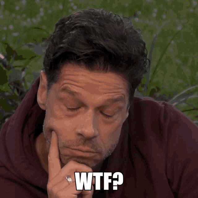 a man with a finger on his chin and the word wtf written below him