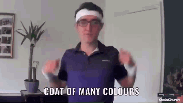 a man wearing glasses and a headband says " coat of many colours "