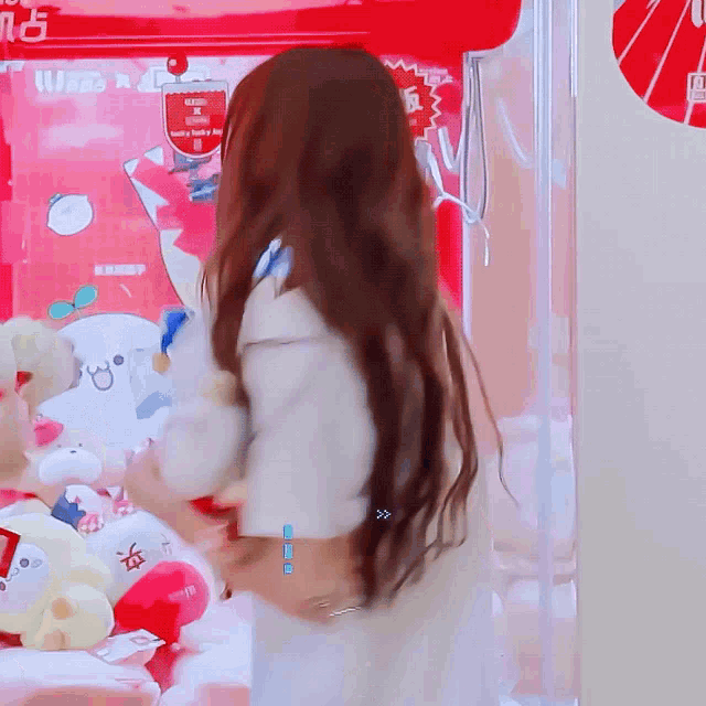 a woman with long hair is standing in front of a red sign that says ' lucky draw ' on it
