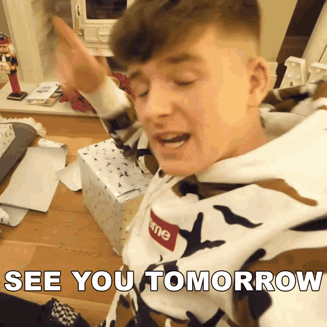 a young man wearing a supreme sweatshirt says see you tomorrow