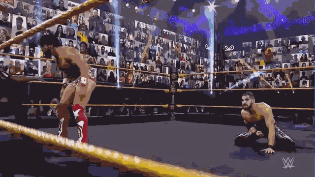 two wrestlers in a wrestling ring with the w logo on the bottom