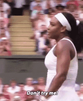 a woman in a white dress says " do n't try me " in front of a crowd