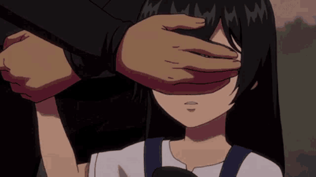 a man covering a girl 's eyes with his hands