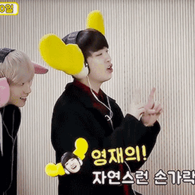 a man wearing headphones with yellow ears is talking to another person