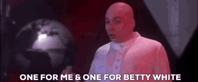 a bald man is standing in front of a globe and says one for me and one for betty white