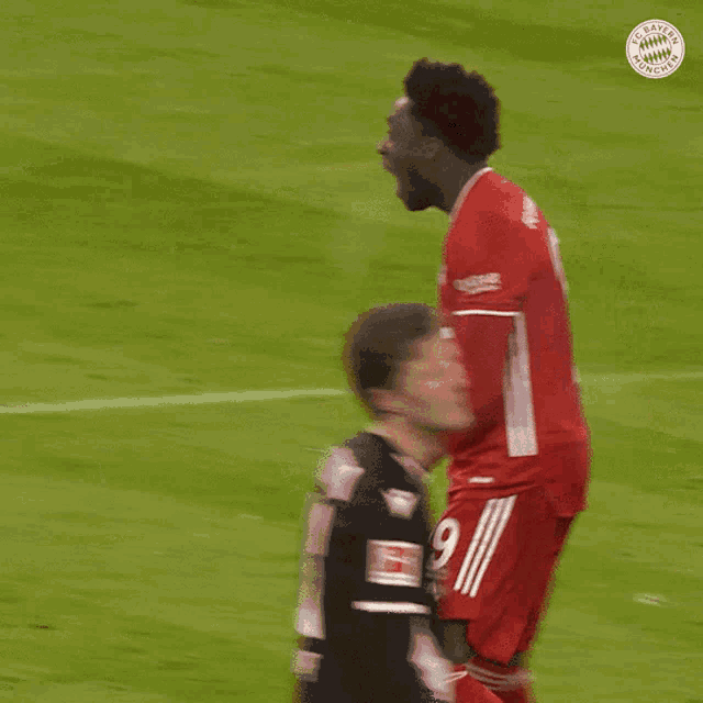 a soccer player wearing a red jersey with the number 27 on it