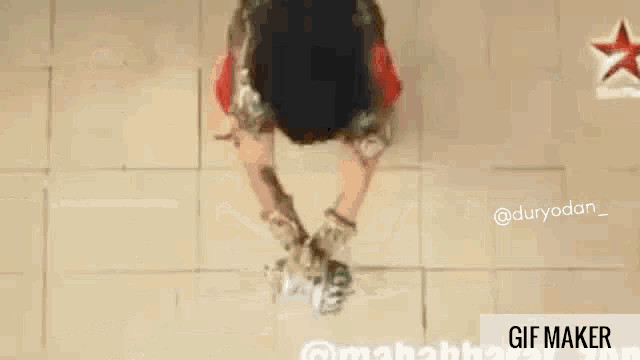 a gif of a man in a red outfit holding a ball