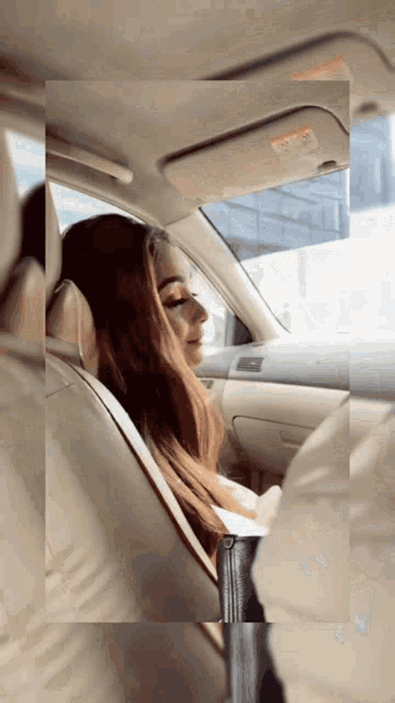 a woman is sitting in the back seat of a car