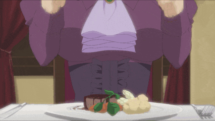 a woman sitting at a table with a plate of food on it