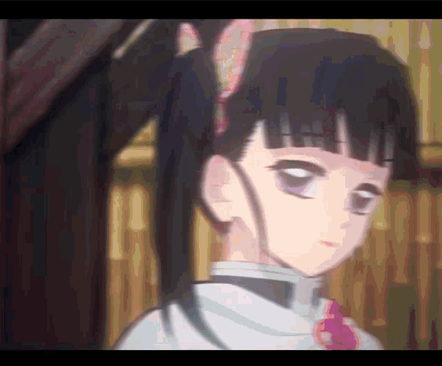 a close up of a girl with black hair and purple eyes .