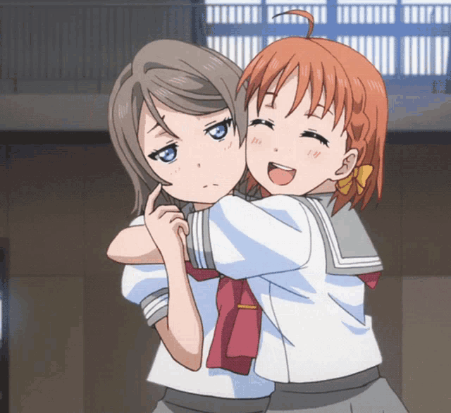 two anime girls are hugging each other and one of them is making a funny face