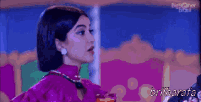 a woman in a pink dress with the word brilharafa on the bottom right