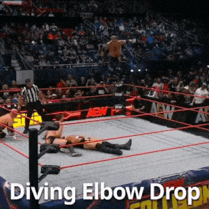 a wrestler is diving elbow dropping another wrestler in the ring