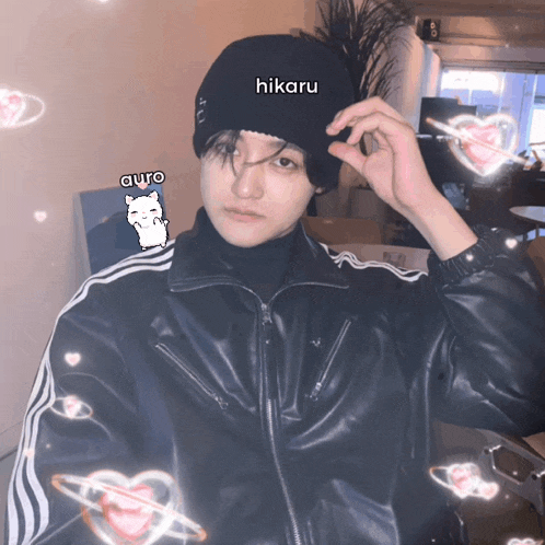 a person wearing a black jacket and a beanie with the name hikaru on it