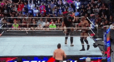 a couple of men are wrestling in a wrestling ring .