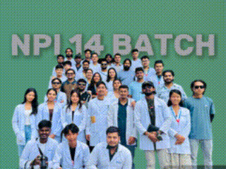 a group of people are posing for a picture with the words npi 14 batch behind them .