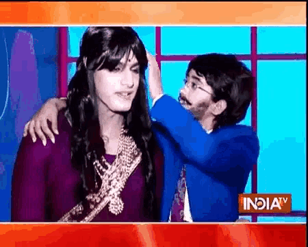 a man is putting a wig on a woman 's head on a tv screen .
