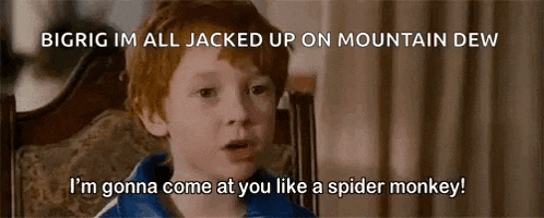 a young boy with red hair is sitting in a chair and talking to someone .