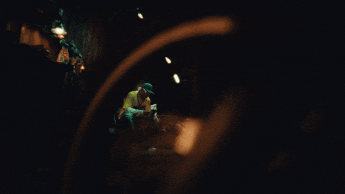 a blurry picture of a person 's face in a dark room at night