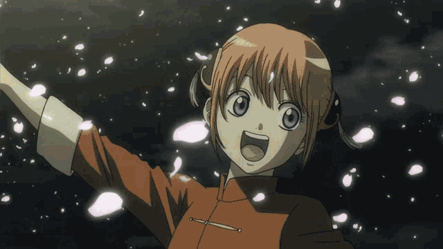 a man with his arms outstretched is surrounded by petals falling from the sky