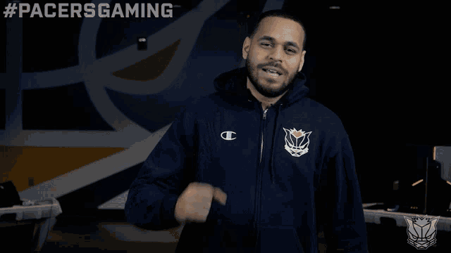 a man in a pacers gaming hoodie is pointing
