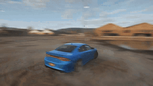 a blue dodge charger is driving through a dirt road