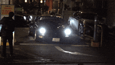 a row of cars are parked on a street with a sign that says 2.00
