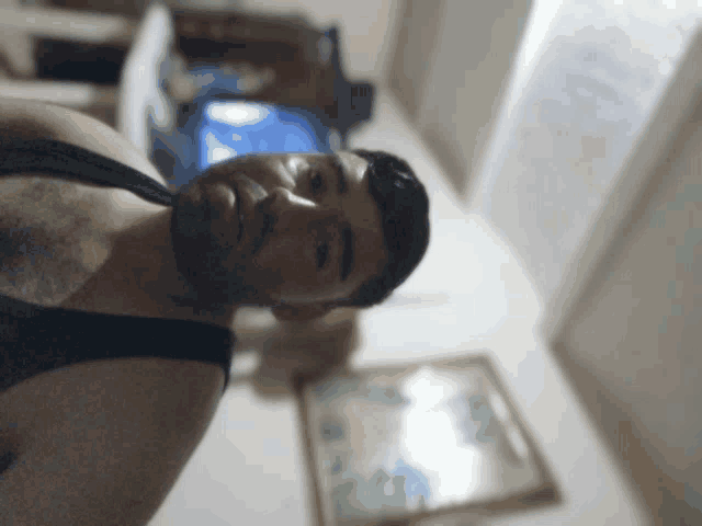 a man with a beard wearing a tank top