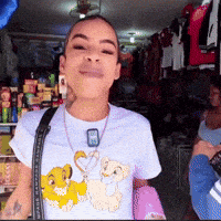 a woman wearing a lion king t-shirt with simba and nala on it
