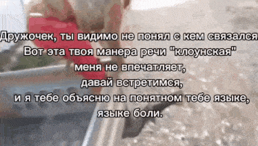 a person holding a red heart with a foreign language written above it