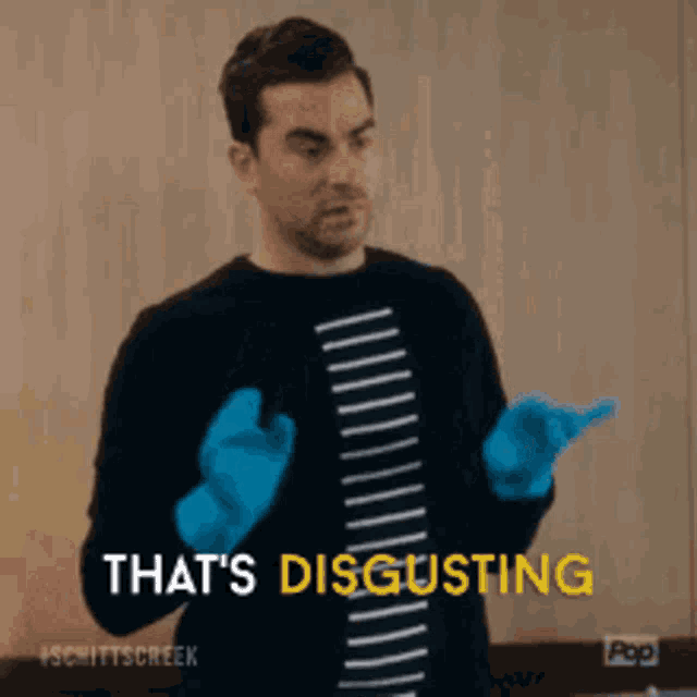 a man wearing blue gloves is saying that 's disgusting .