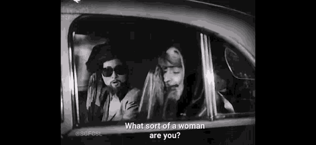 a man and a woman are sitting in a car . the man is asking the woman what sort of a woman are you .